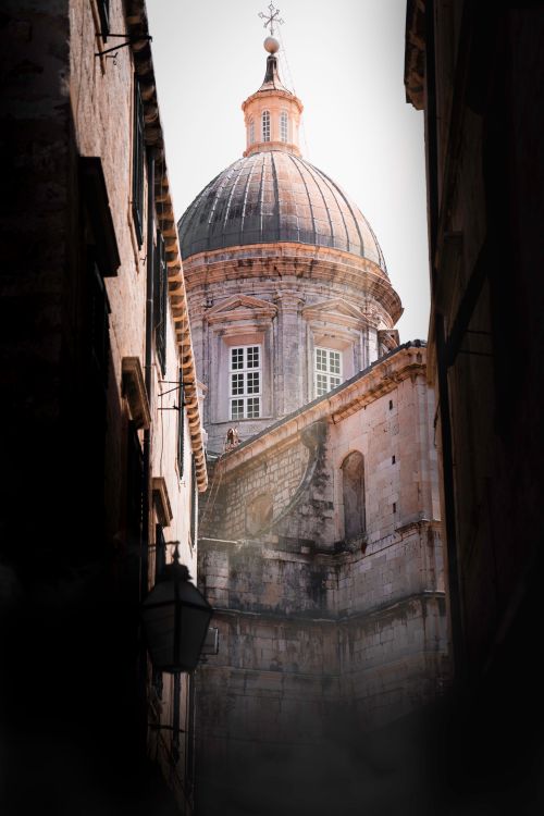 Free View of a historic dome through a narrow alley in Dubrovnik's Old Town, Croatia. Stock Photo