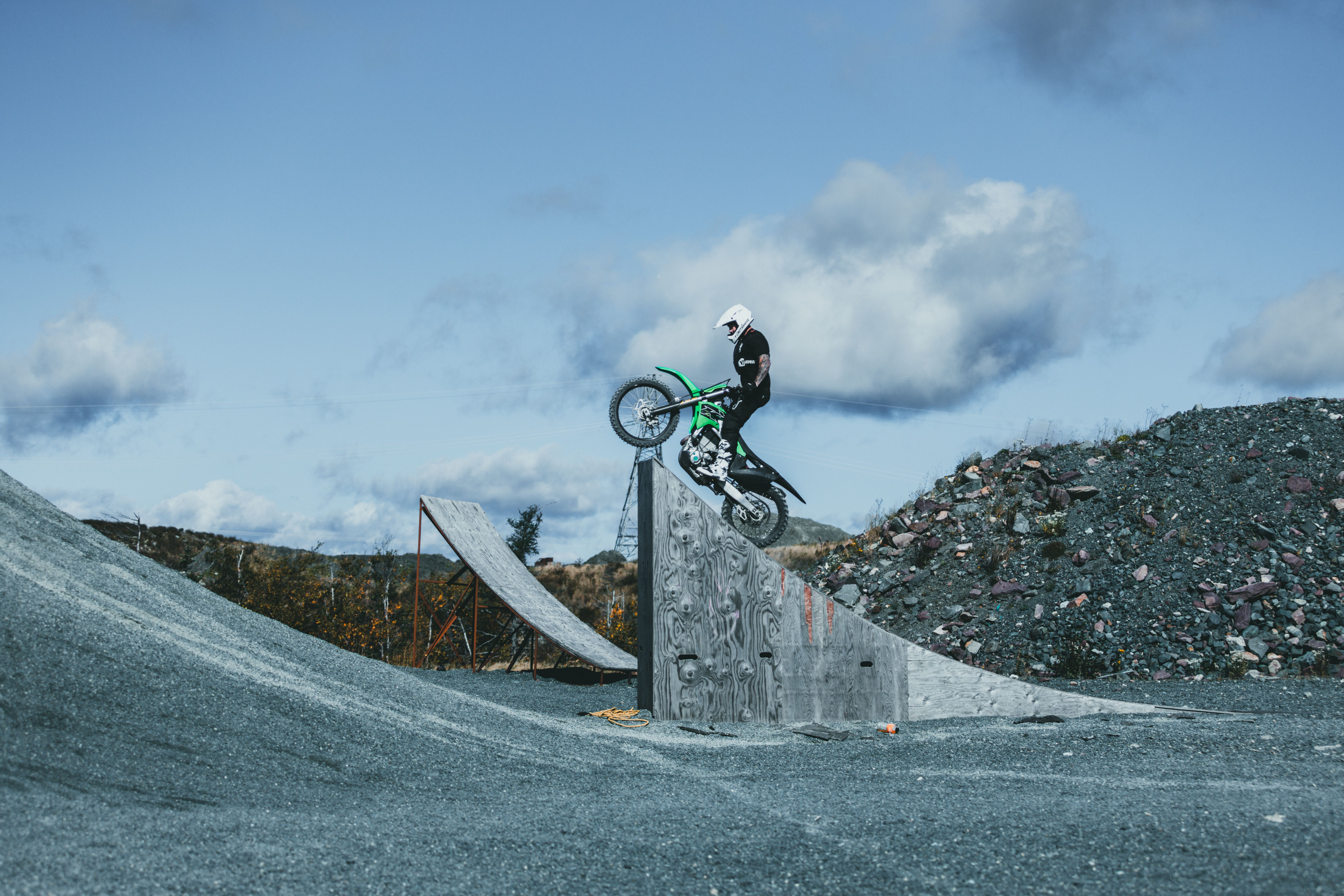 Daring Motorcycle Stunt on Outdoor Dirt Ramp · Free Stock Photo