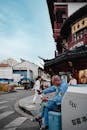 Man Relaxing on an Urban Street Corner in Shanghai