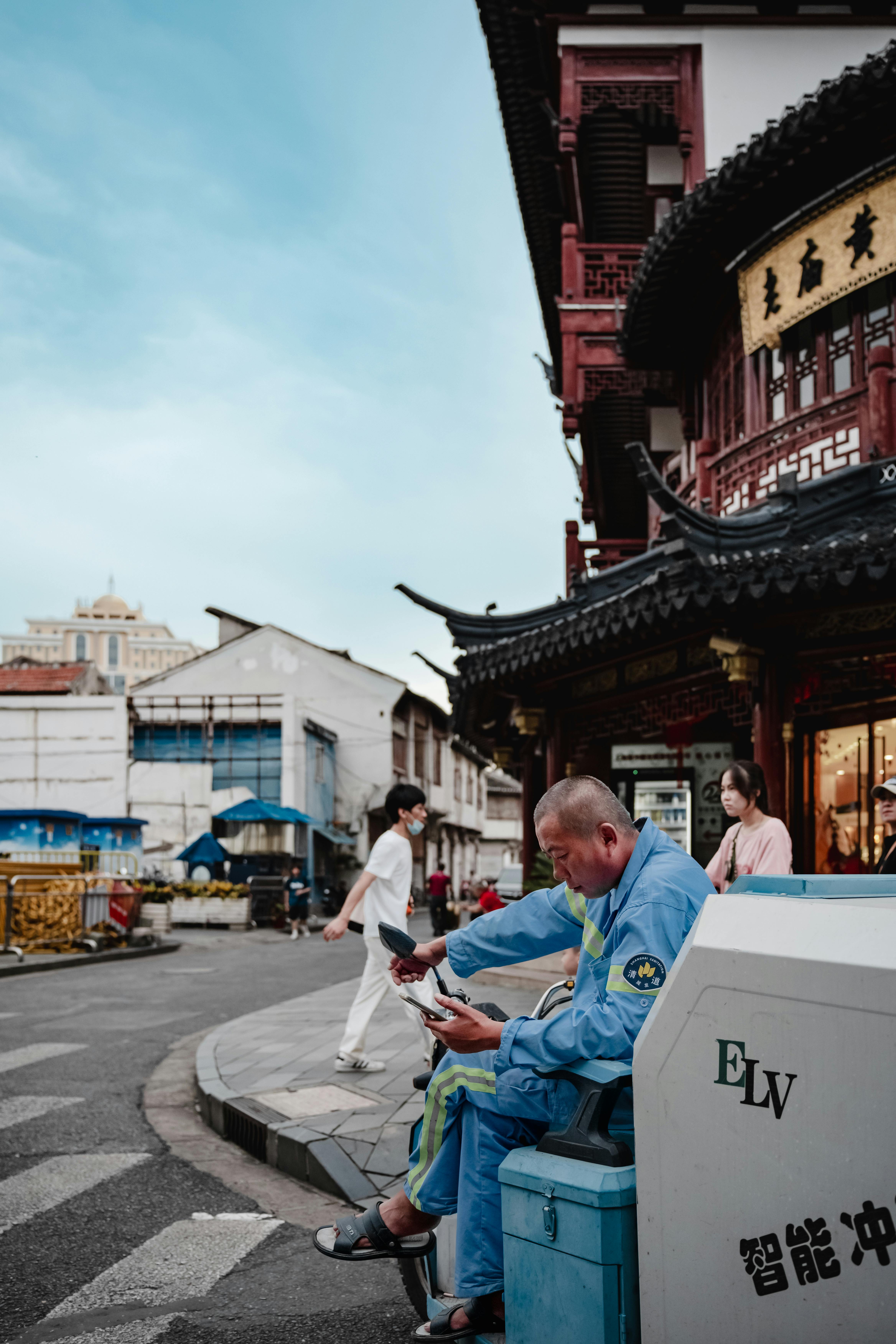 Man Relaxing on an Urban Street Corner in Shanghai