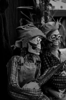 Monochrome image of two skeleton figures dressed in plaid, one playing a banjo.