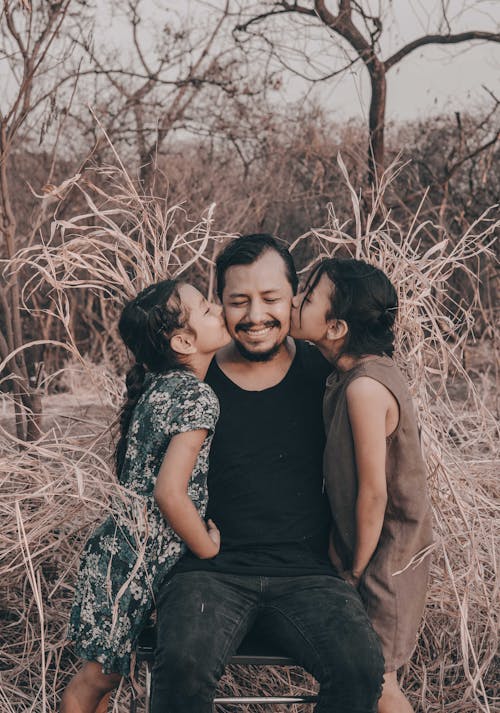 Free Daughters Kissing their Father  Stock Photo