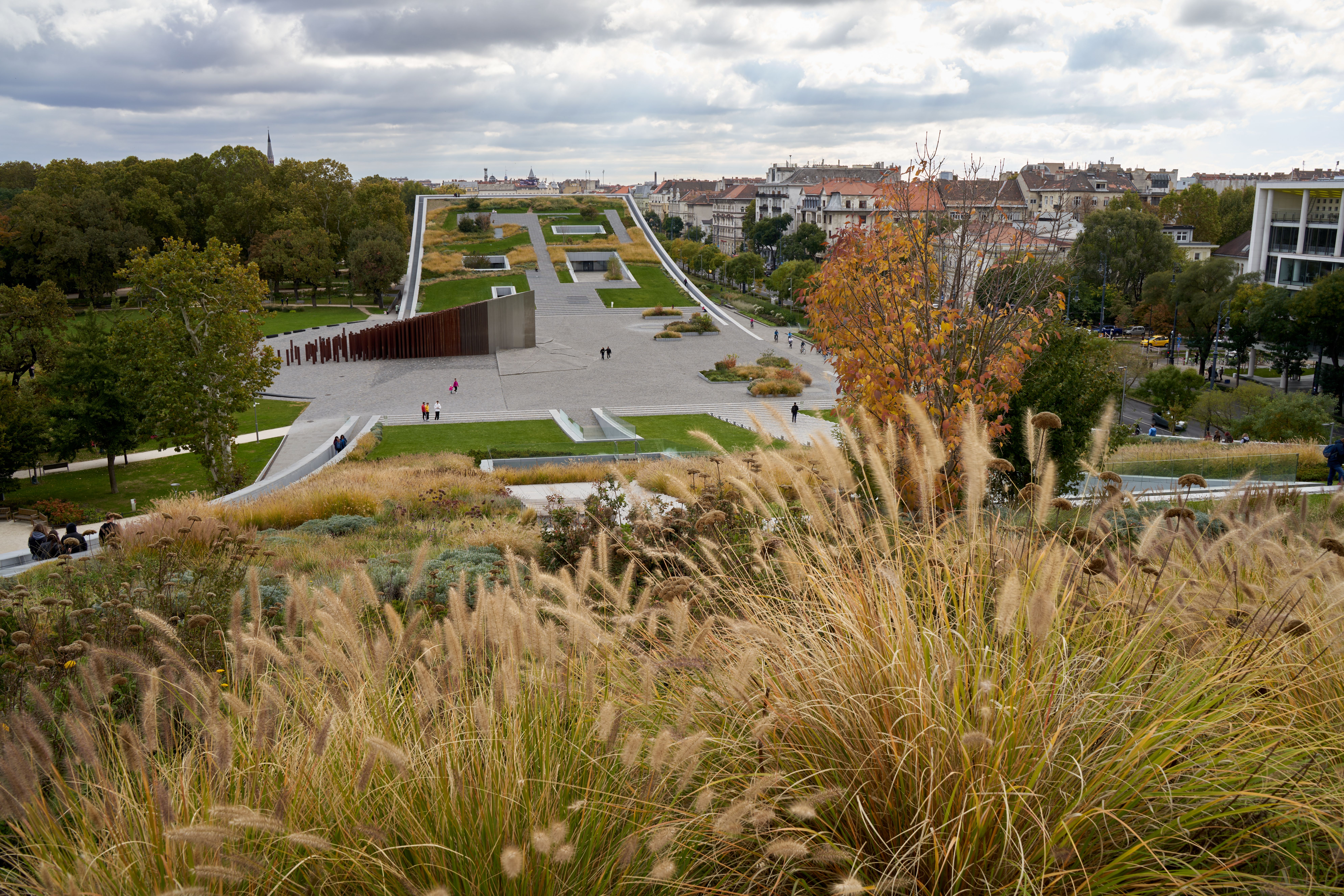 Aerial view of park landscape in Budapest during autumn, showcasing vibrant foliage.