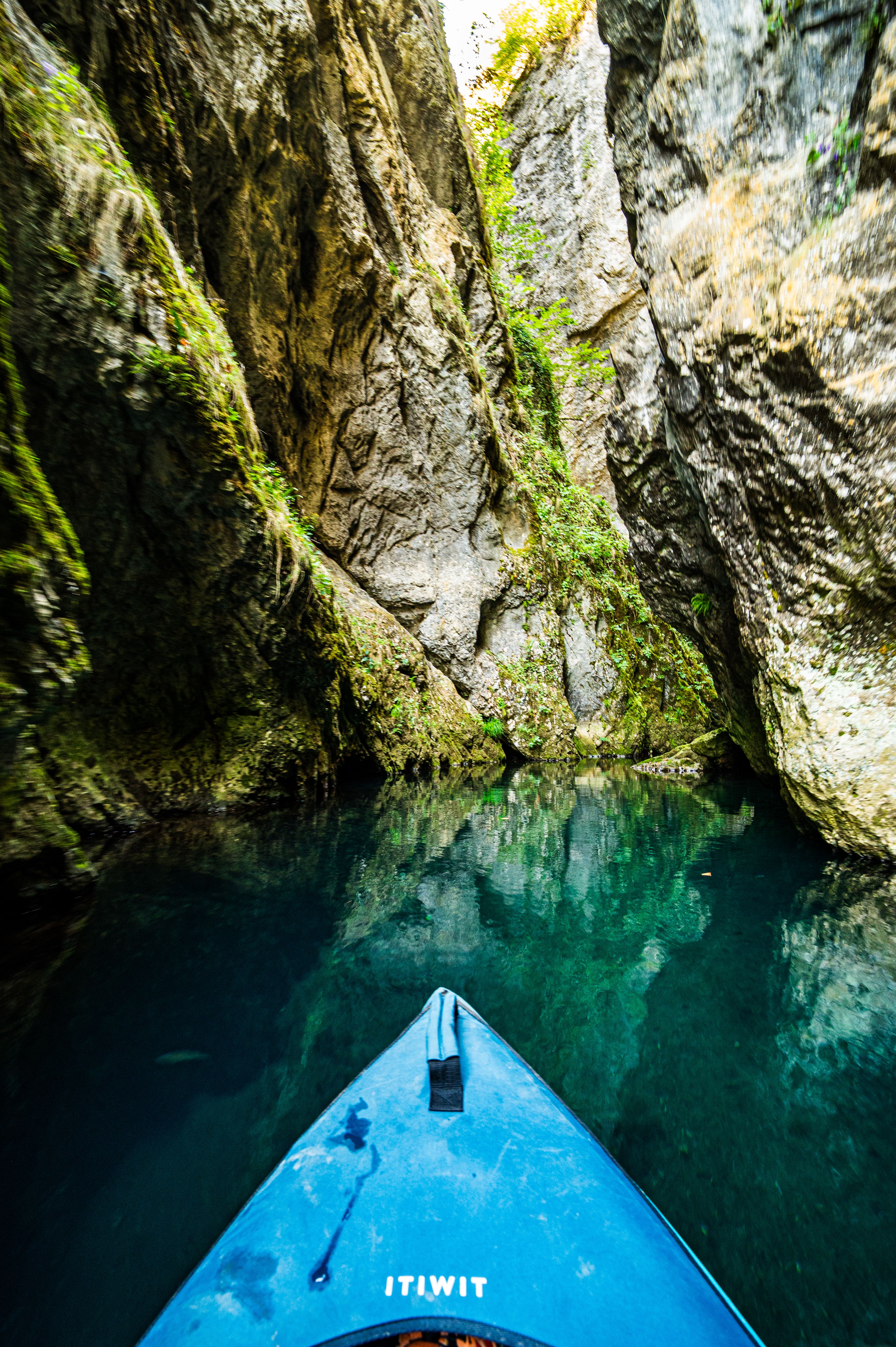 Immerse in the beauty of kayaking through a tranquil, moss-covered gorge.