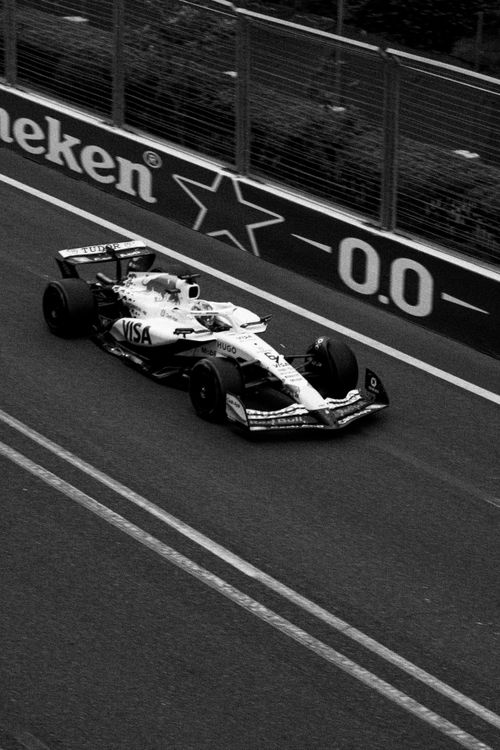 Free A Formula 1 race car on a track in black and white, highlighting speed and precision. Stock Photo