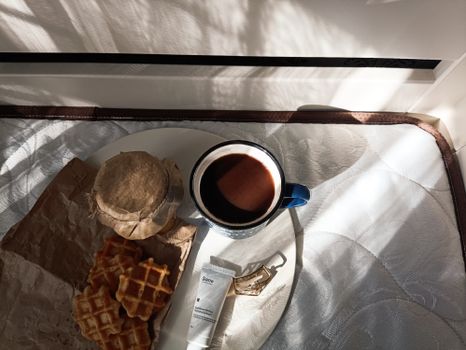 A cozy morning breakfast scene with coffee, waffles, and sunlight creating a serene atmosphere.