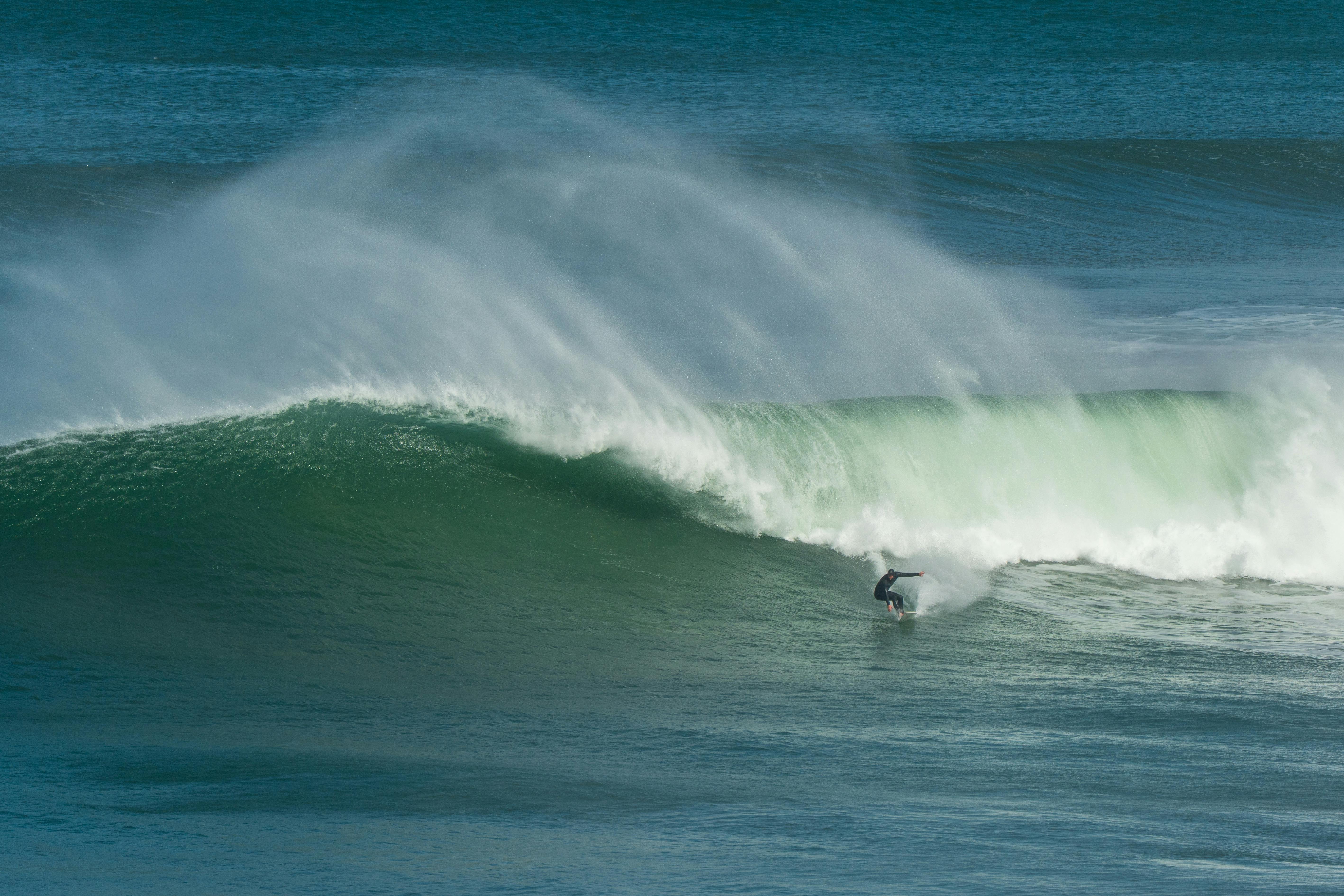 A thrilling surfing scene with a surfer riding a giant wave at Bells Beach, Victoria.