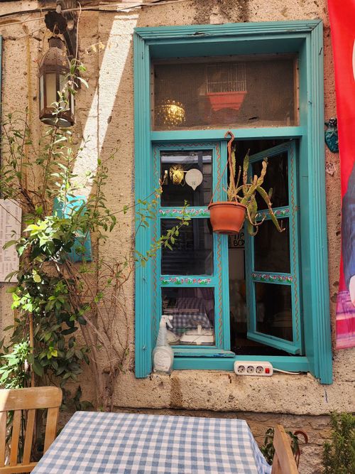 Free A vibrant blue window adorned with rustic decor in a cozy outdoor setting. Stock Photo