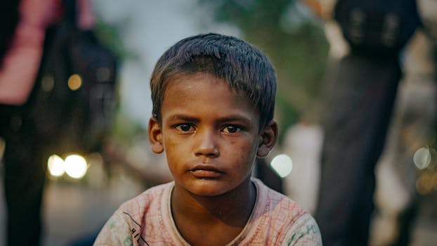 Captivating portrait of a young boy in the streets of Delhi, India, conveying depth and emotion.