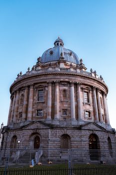 A daytime view of the iconic Radcliffe Camera in Oxford, England, showcasing its classic architectural style.