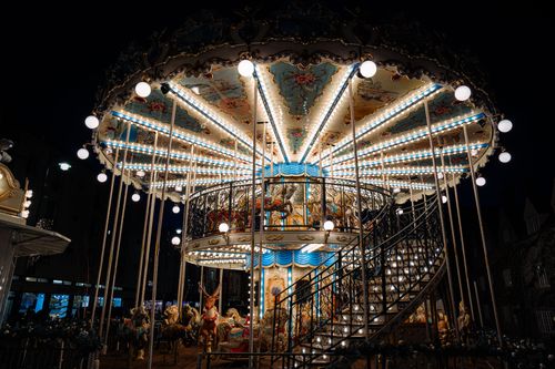 Free A beautifully lit carousel glows against the night sky in Oxford, England, capturing a magical fairground scene. Stock Photo