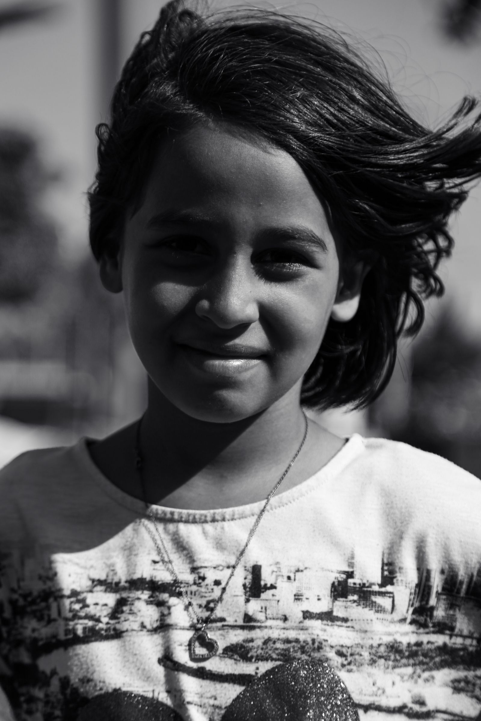Black and White Portrait of a Smiling Girl Outdoors · Free Stock Photo