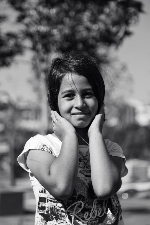 Black and White Portrait of a Smiling Girl Outdoors · Free Stock Photo