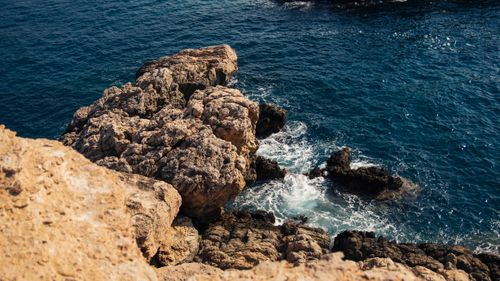 Free Explore a dramatic rocky coastline with waves crashing against the shore, a perfect scene capturing nature's power. Stock Photo