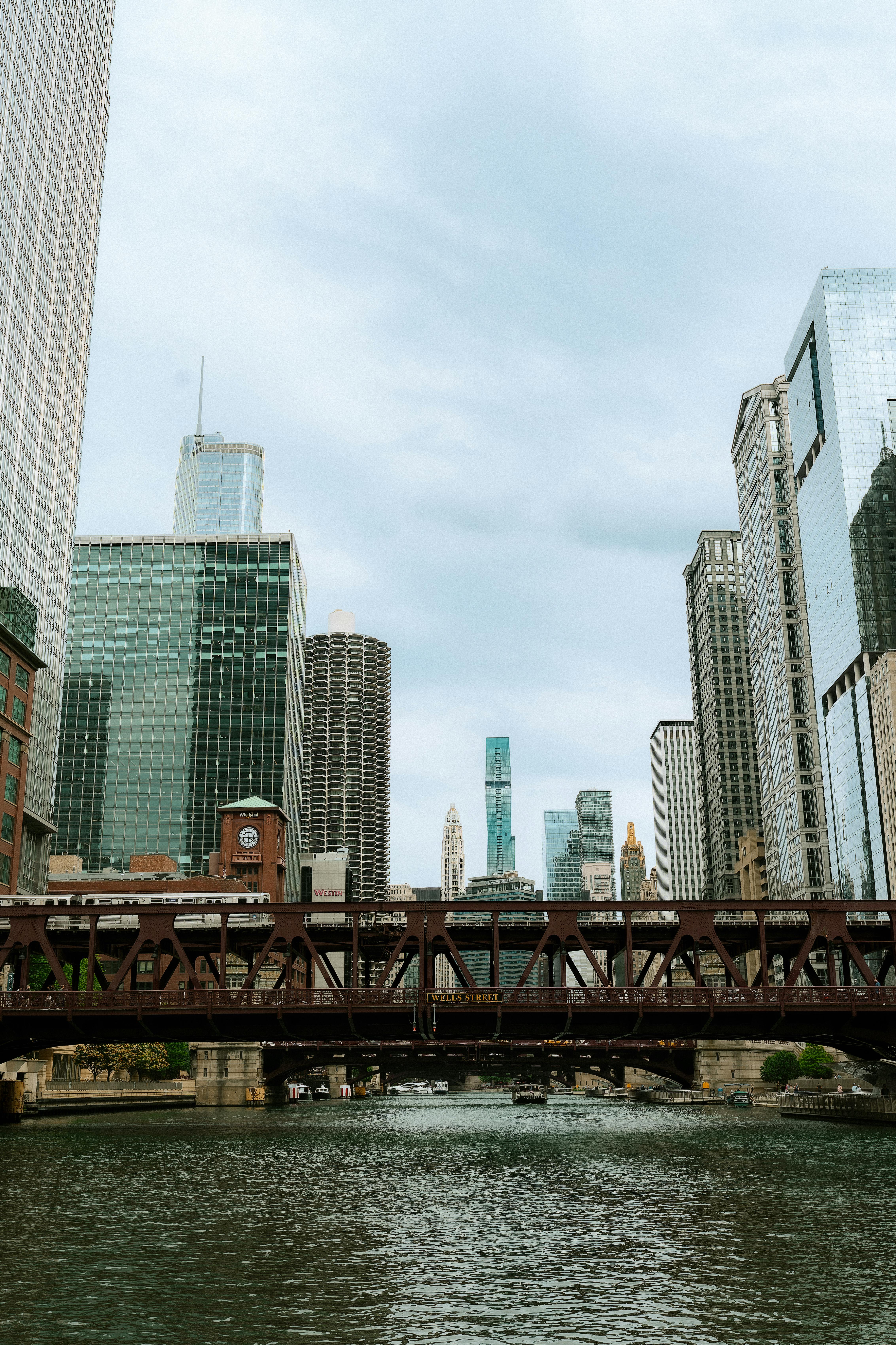 View of Chicago's skyline featuring the iconic bridge and towering skyscrapers on a cloudy day.