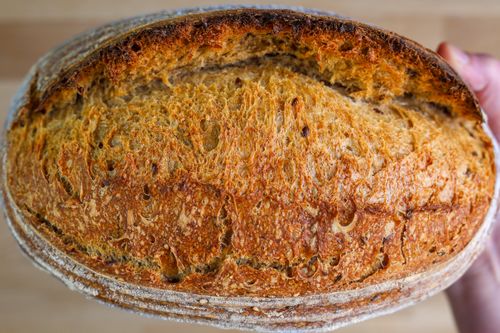 Free Close-up of freshly baked artisan sourdough bread with a golden crust texture. Stock Photo