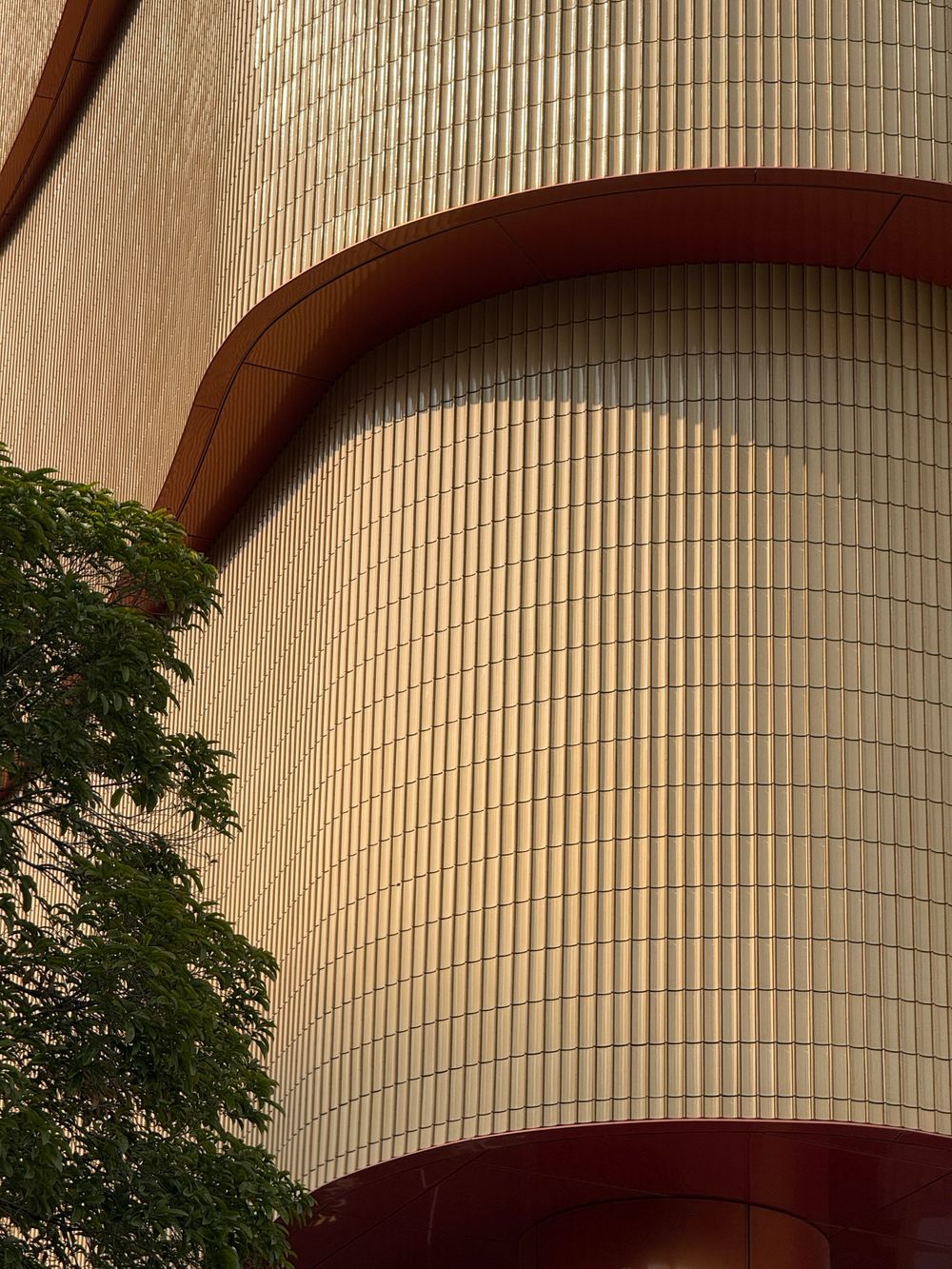 Curved terracotta facade detail of a modern building