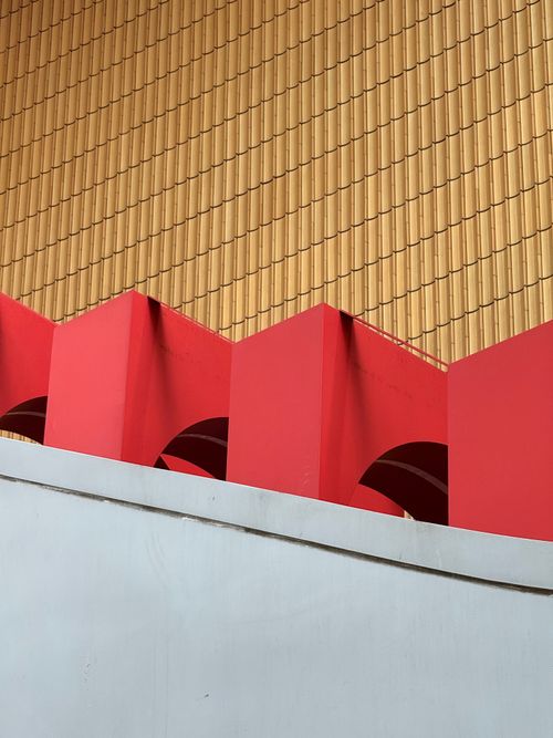 Free Dynamic abstract shot of geometric architecture with bold red and yellow tones. Stock Photo