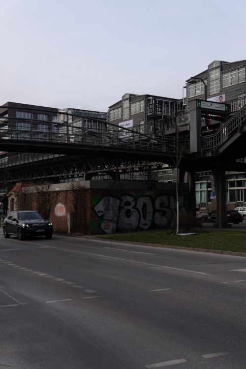 Free Street view of modern industrial architecture in Hamburg's HafenCity with graffiti and a passing car. Stock Photo