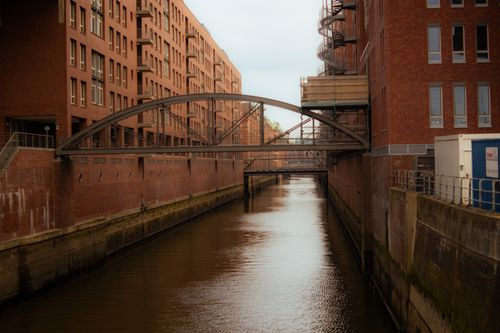 Free Explore the historic architecture and tranquil canal in Hamburg's renowned Speicherstadt district. Stock Photo