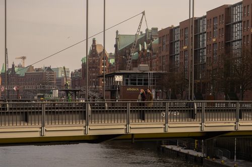 Free Enjoy a scenic view of Hamburg's historic architecture with people strolling across a bridge. Stock Photo