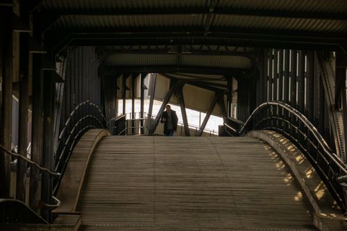 Free Inside view of a metal bridge in Hamburg with people walking, showcasing urban architecture. Stock Photo
