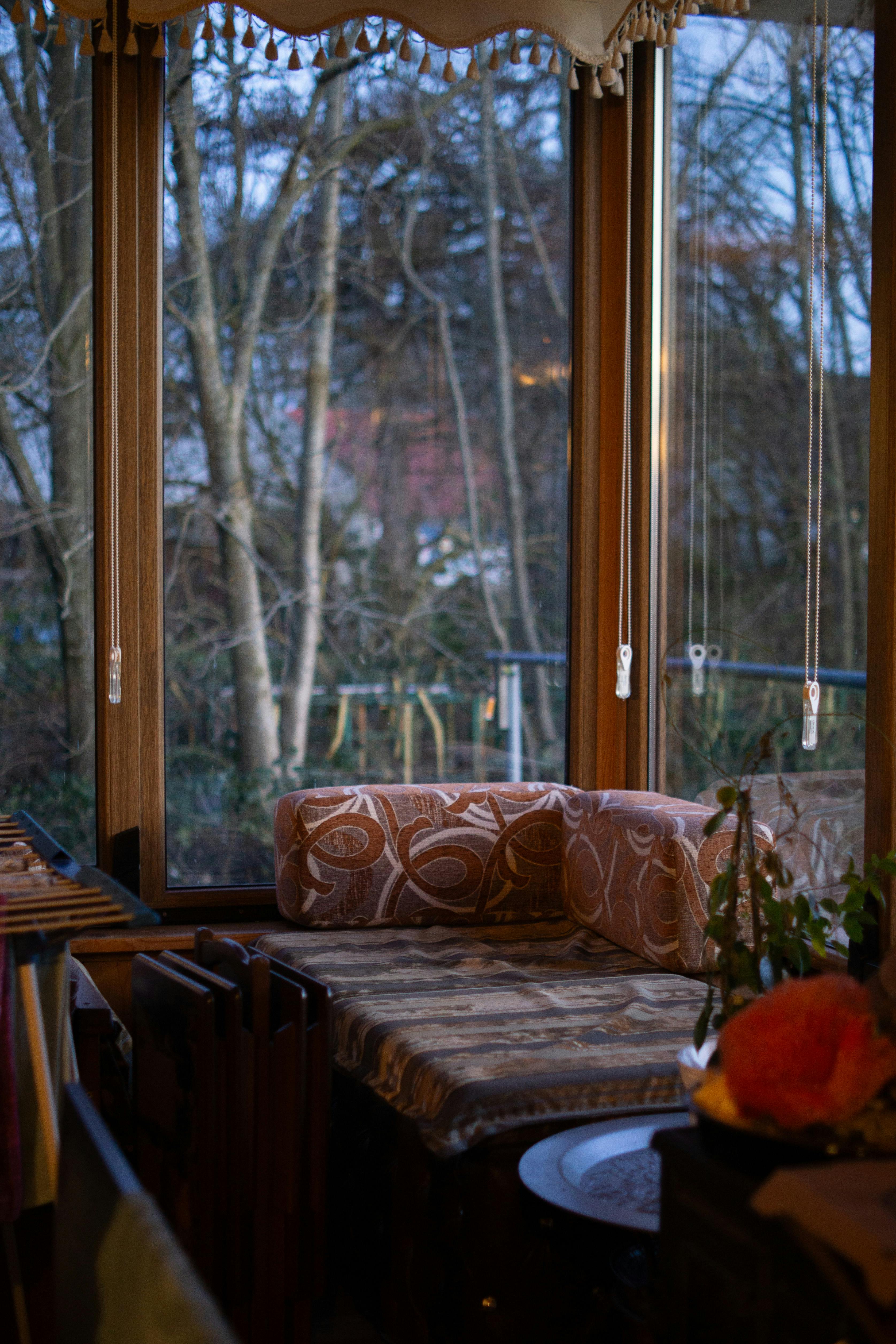 Warm indoor seating overlooking a winter landscape through large windows.