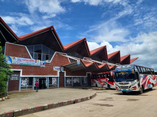 Free A modern bus terminal with unique architecture and colorful buses on a sunny day. Stock Photo