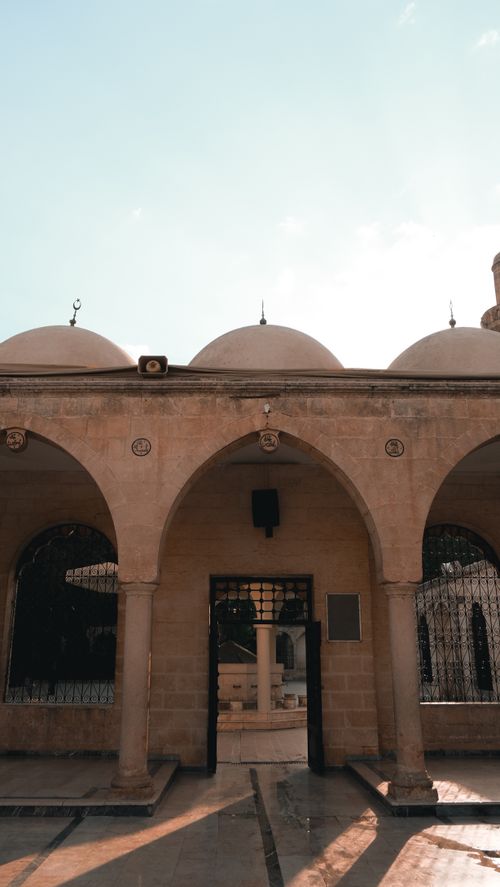 Free Beautiful historic stone archway with domes under a bright clear sky, showcasing traditional architecture. Stock Photo
