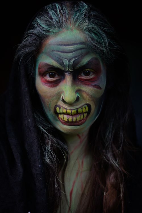 Free Close-up of a person with detailed Halloween face paint, resembling a monster. Stock Photo