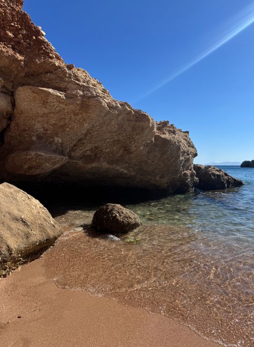 Free Stunning view of a rocky beach shoreline under clear blue skies in Muğla, Türkiye. Stock Photo