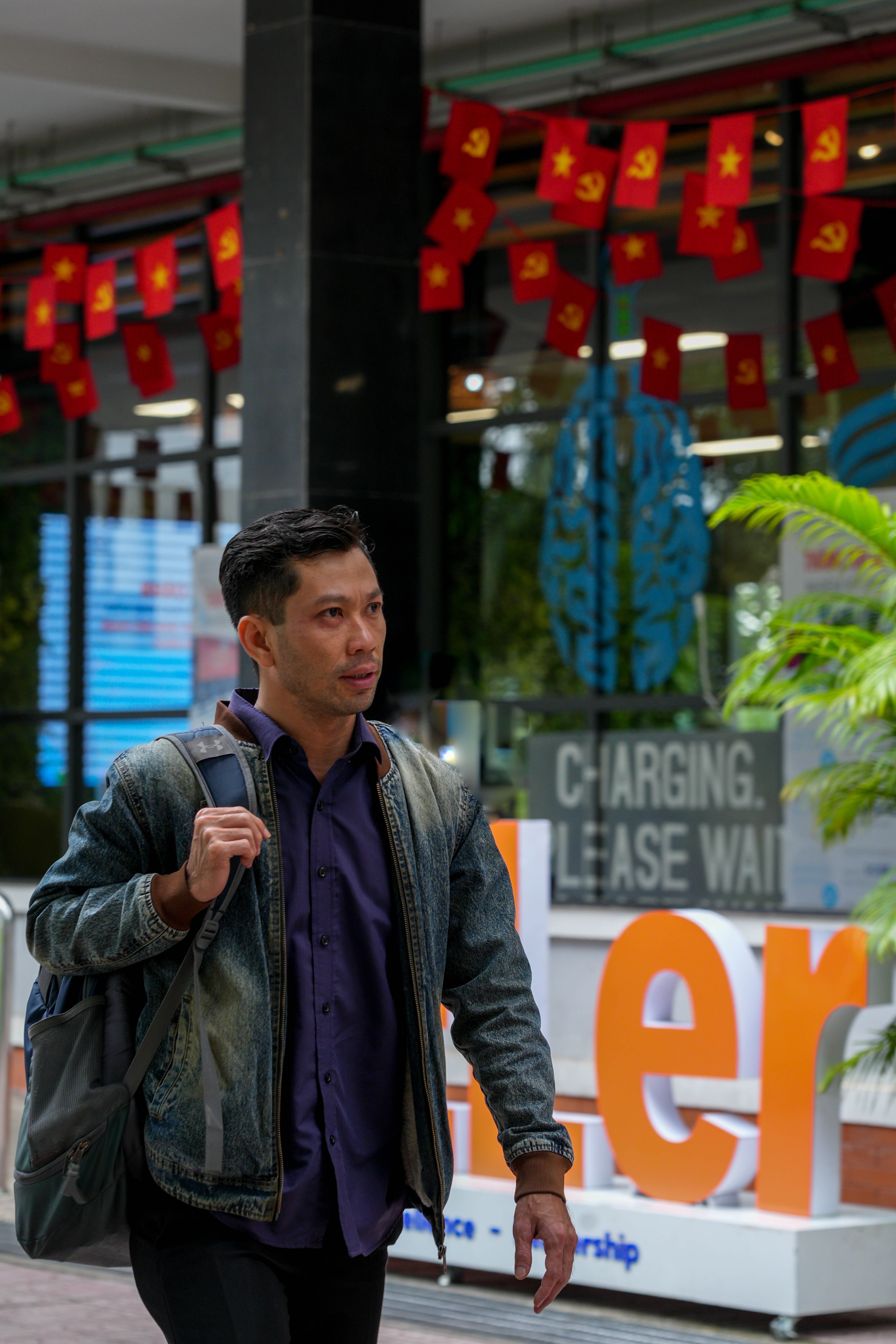 Man Walking Past Decorated Storefront in City · Free Stock Photo