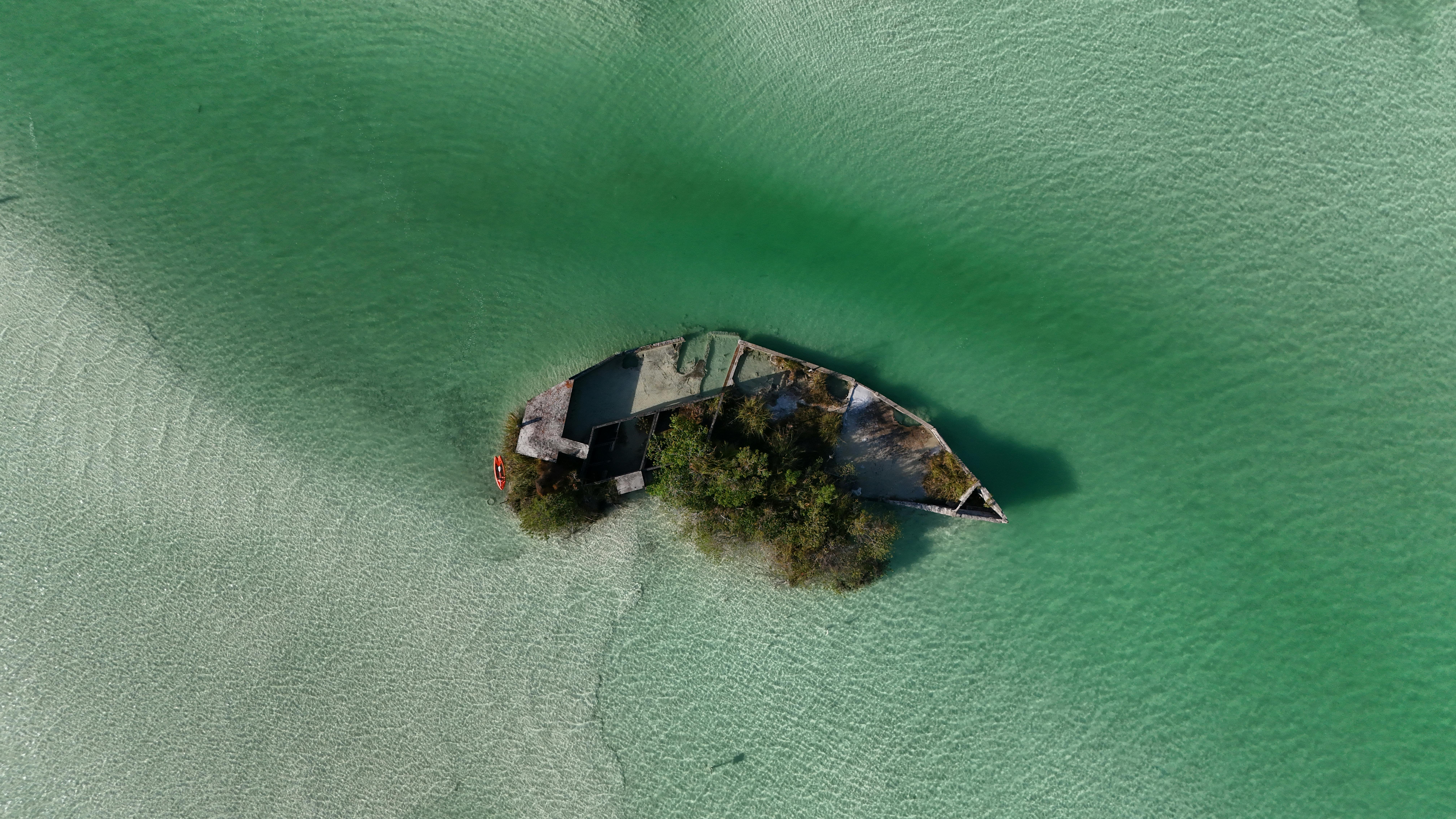 Discover the stunning aerial view of a submerged shipwreck in Bacalar Lagoon, Mexico.