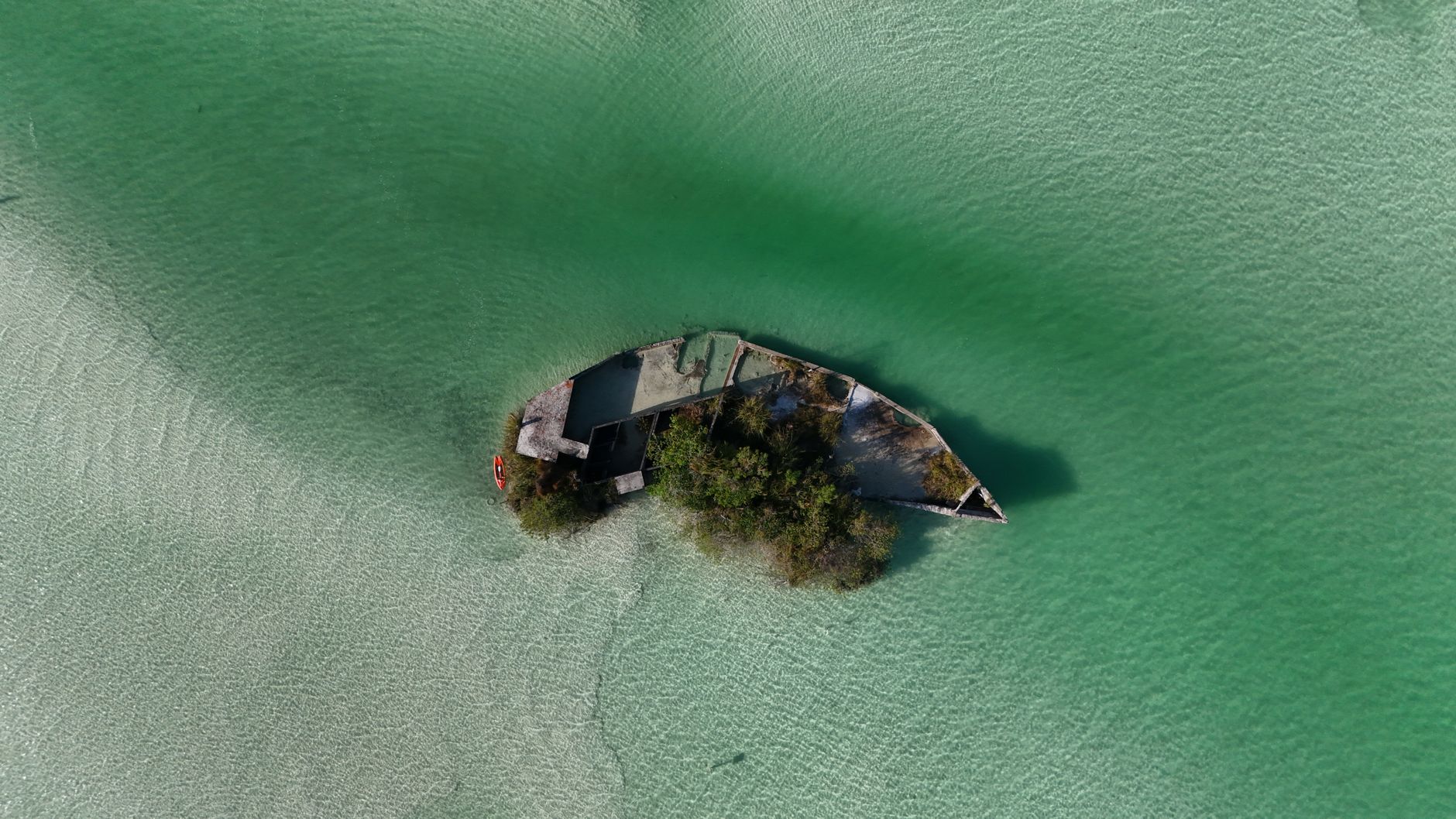 Discover the stunning aerial view of a submerged shipwreck in Bacalar Lagoon, Mexico.