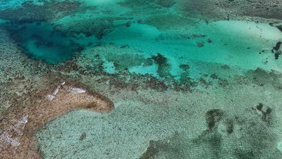 30 minute Reef Scenic Flight - Stunning aerial shot of Bacalar Lagoon showcasing vibrant turquoise waters in Quintana Roo, Mexico.