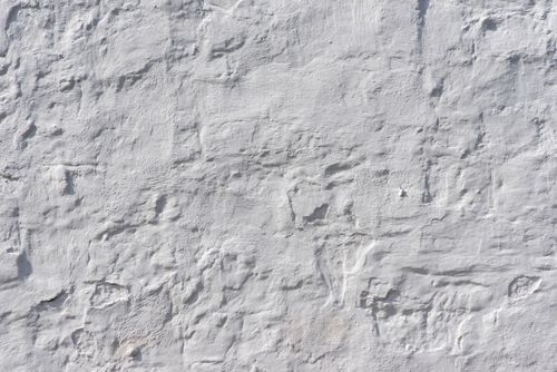 Free Detailed close-up of a textured white plaster wall showcasing its intricate surface patterns. Stock Photo