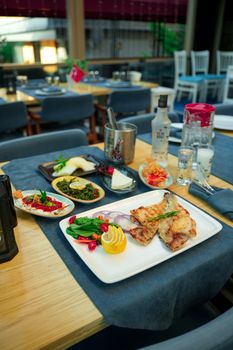 A well-arranged restaurant table showcasing a variety of gourmet dishes, ready for a delightful dining experience. - Fotografer Sidoarjo