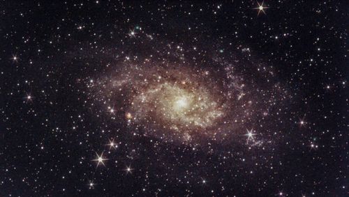 Free Bright spiral galaxy surrounded by stars in deep space. Stock Photo