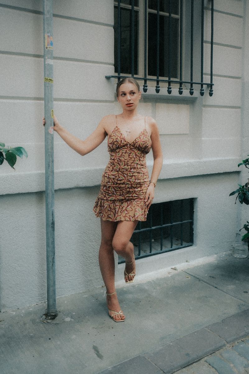 Fashionable woman in a patterned dress on a city street