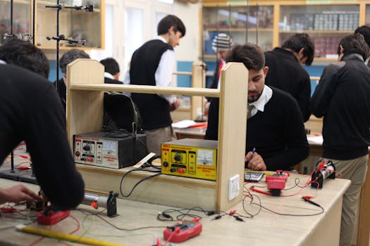 Students working on electronics projects in a lab, focusing on practical learning.