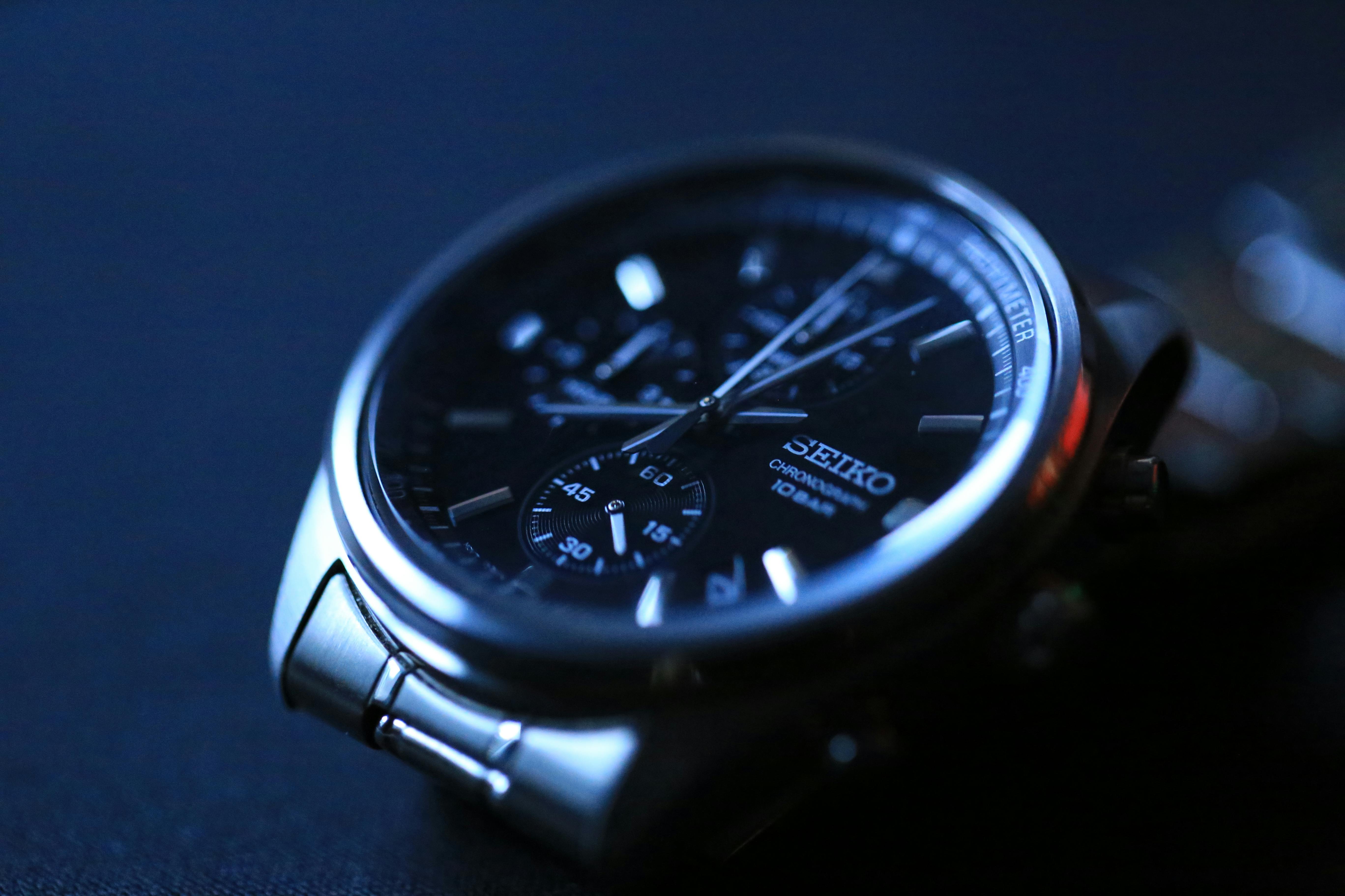 Close-up shot of a luxury Seiko wristwatch with dark metallic details and a sleek design.