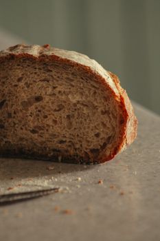 Close-up of a rustic slice of artisan bread on a kitchen counter.
