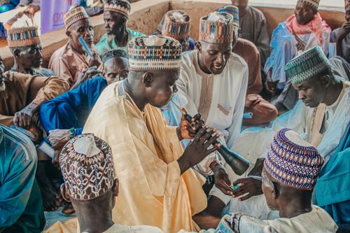Free A group of men in traditional attire participating in a cultural music session in Nigeria. Stock Photo