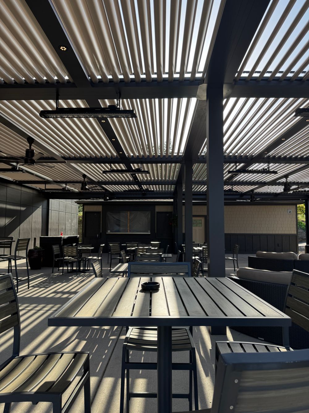 Modern outdoor patio with metal furniture and a pergola