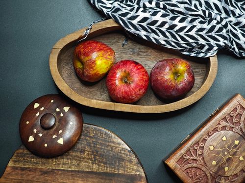 Free Aesthetic flat lay composition featuring fresh apples in a wooden bowl with rustic kitchen elements. Stock Photo