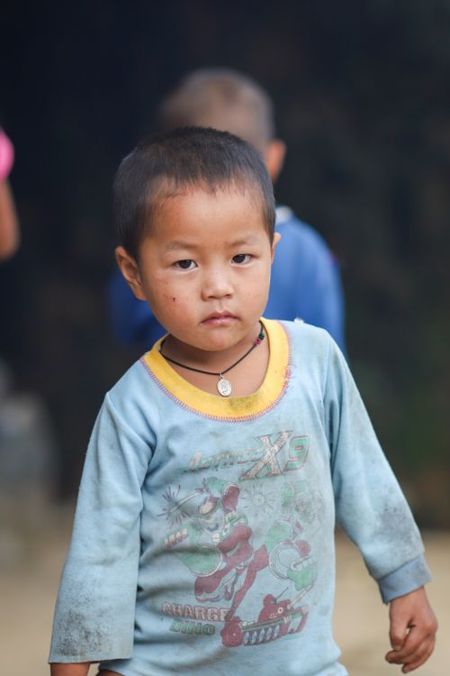 Free Emotive portrait of a young child outdoors in Lào Cai, Vietnam, highlighting cultural attire and expression. Stock Photo
