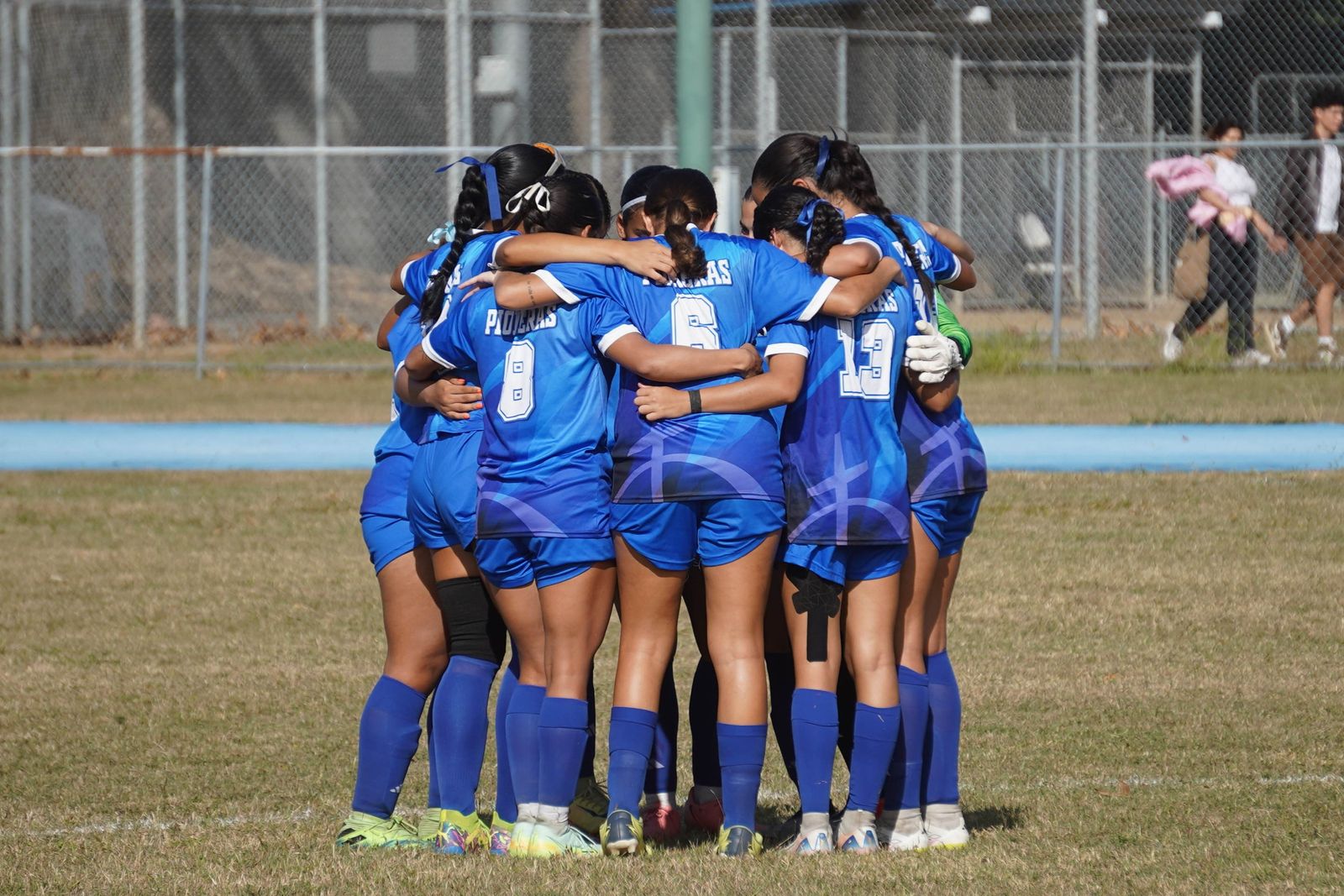 Women players in a team huddle