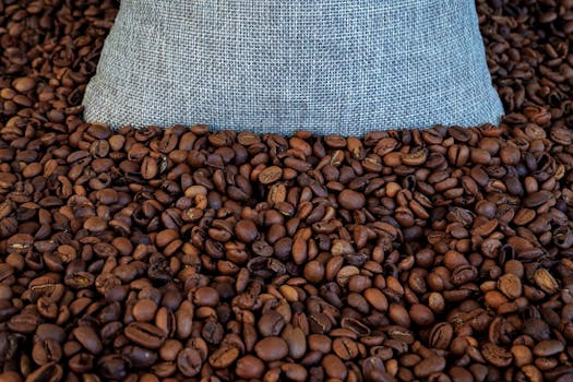 Rustic burlap bag filled with roasted coffee beans, perfect for artisanal or organic themes.
