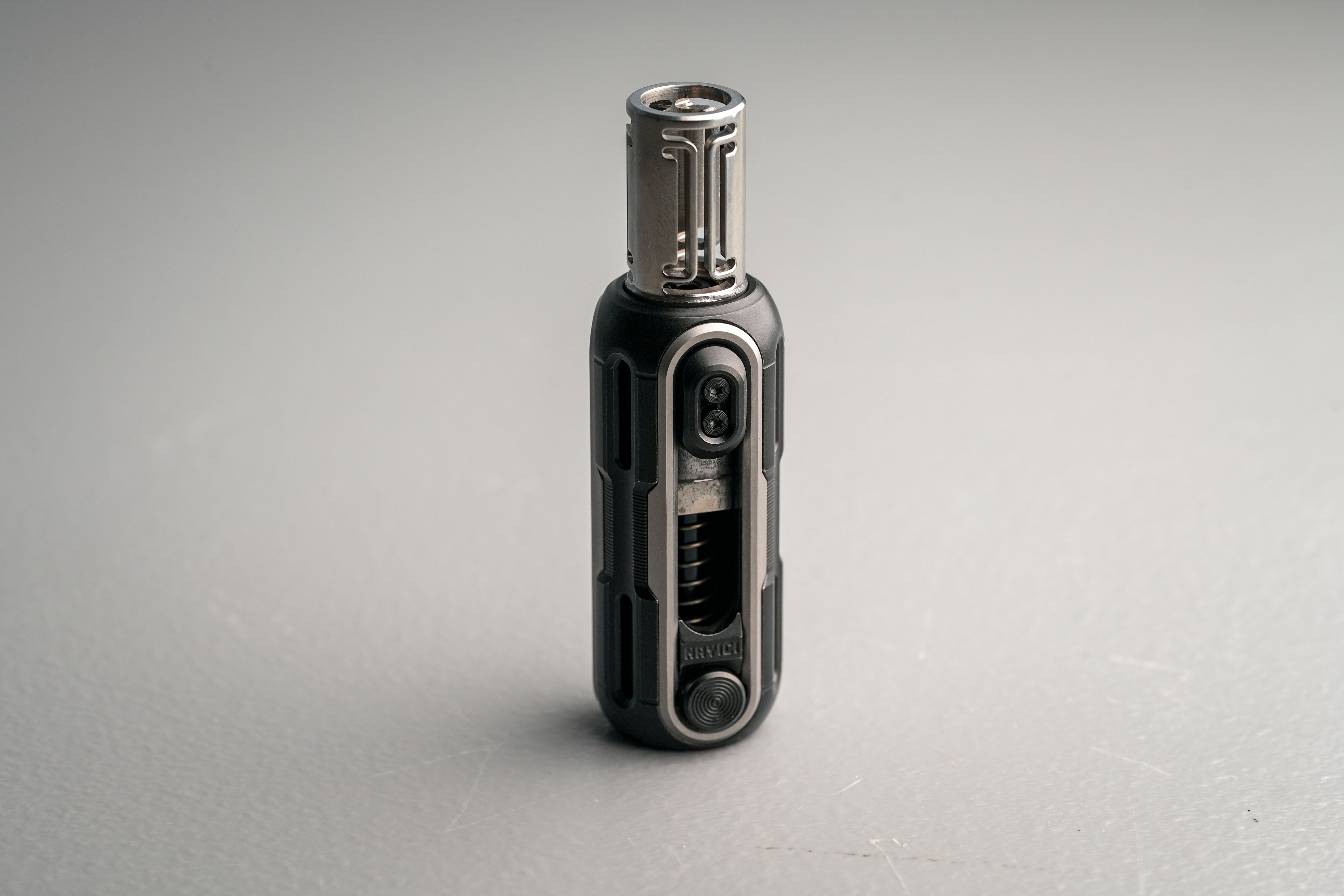 Sleek Metal Torch Lighter on Gray Surface · Free Stock Photo