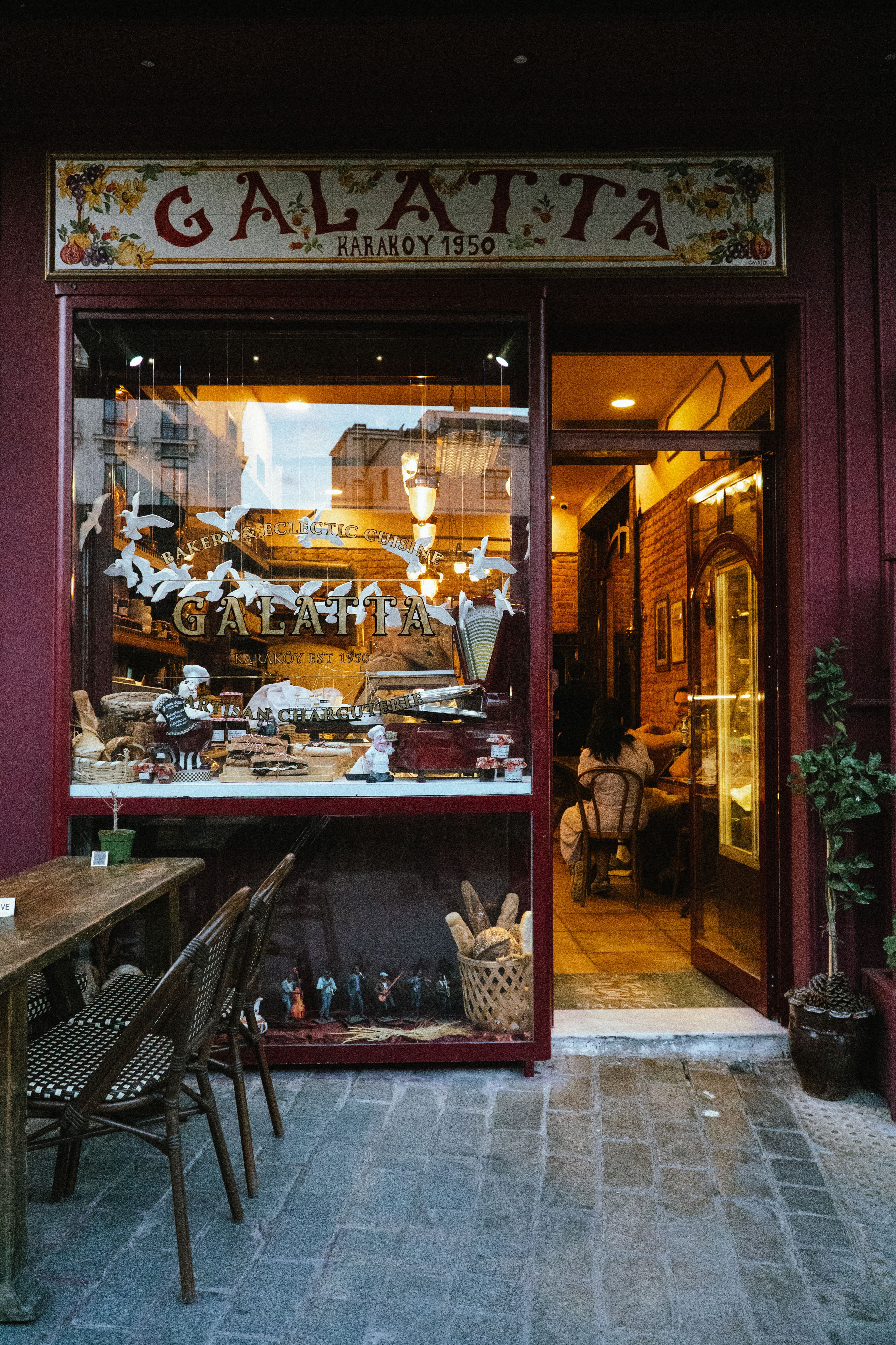Charming vintage café in Istanbul's Karaköy district, warm and inviting ambiance at dusk.